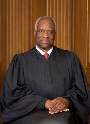 A black man in a robe sitting in a chair, reflecting the impact of legislation and the influence on kids in churches.