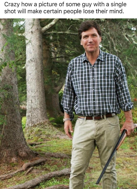 A man in a plaid shirt and khaki pants stands in a forest holding a firearm, with a humorous text caption above about reactions to the image.