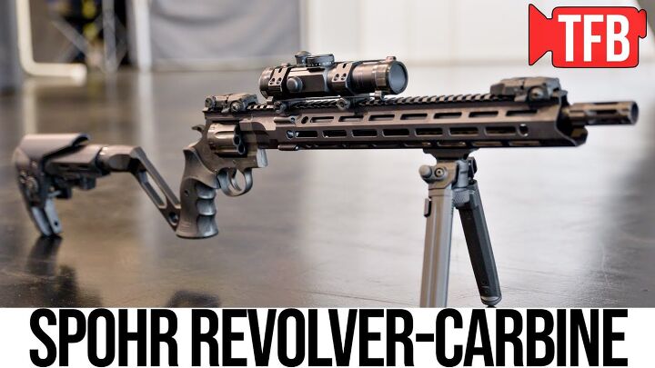 A Spohr revolver-carbine with an adjustable stock, bipod, and scope is displayed on a table.