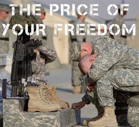 Two soldiers in uniform kneel and grieve in front of a fallen comrade's boots, helmet, and rifle; text above reads "The Price of Your Freedom.