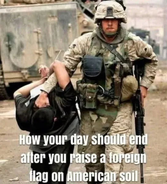 A US soldier detains a person in black clothing, leading them away with one arm behind their back; military vehicles are in the background. Text overlay discusses consequences for raising a foreign flag.