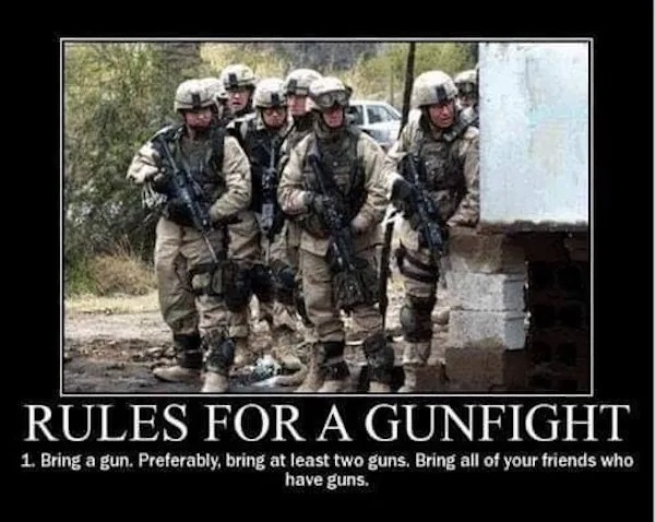 A group of armed soldiers in uniform stand together beside a building. Text below reads: "Rules for a gunfight: 1. Bring a gun. Preferably, bring at least two guns. Bring all your friends who have guns.
