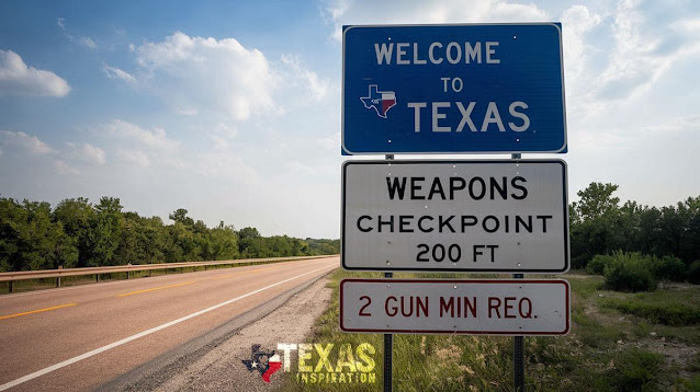 A road sign reads "Welcome to Texas," with additional signs below stating "Weapons Checkpoint 200 ft" and "2 Gun Min Req." Trees and a road are visible beside the signs.