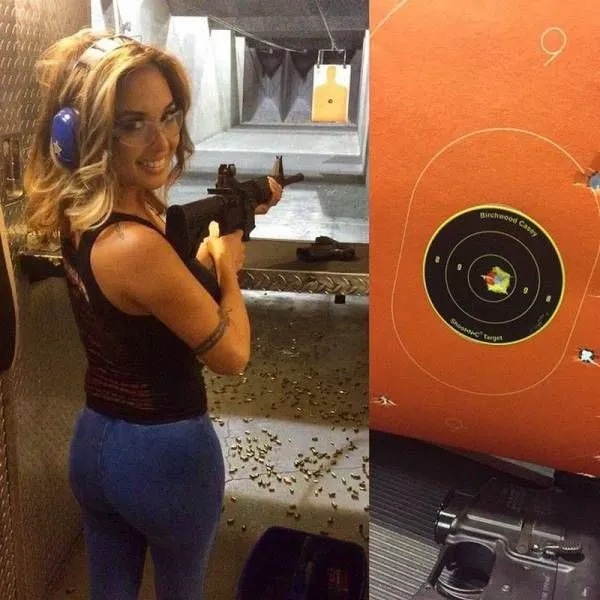 A woman wearing ear protection holds a rifle at an indoor shooting range, with a paper target showing bullet holes on the right side of the image.