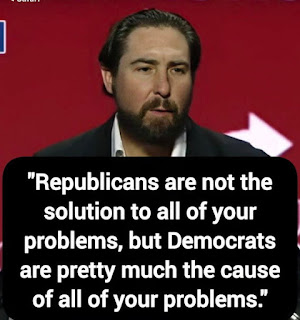 A man with a beard speaks in front of a red background; overlaid text criticizes Democrats and Republicans regarding political problems.