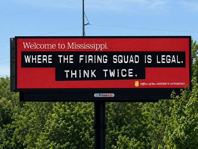 A billboard reads: "Welcome to Mississippi. Where the firing squad is legal. Think twice." with the Office of the District Attorney logo on a red background.